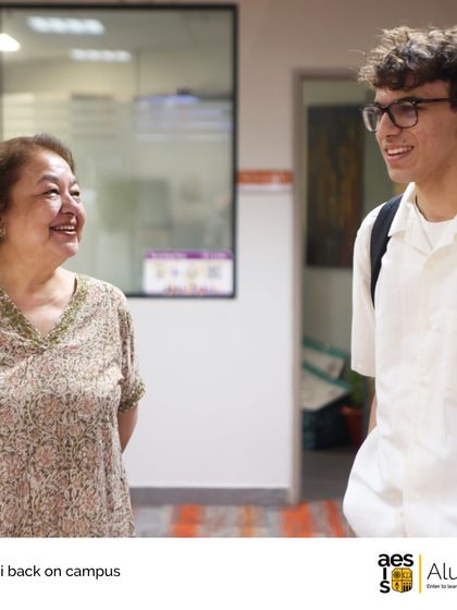 A recent graduate shares a smile with a long-time faculty member. The intergenerational connections are a special part of our school's culture.