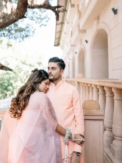 A romantic and intimate moment between the couple. The bride's hair looks effortlessly beautiful, with soft waves and a simple braid.