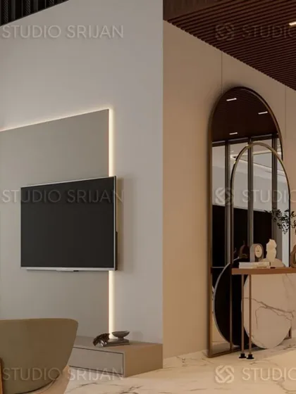 A detail of the TV wall with minimalist backlighting, paired with an arched mirror and console table to create a stylish and functional corner.