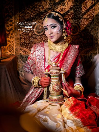 This image captures the traditional elements of a Bengali bride, including the saree drape and gold jewelry, which are part of our comprehensive bridal styling training.