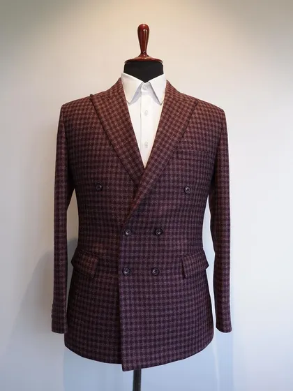 This classic double-breasted jacket in a maroon check flannel wool is a gentleman's pick for the cooler seasons.