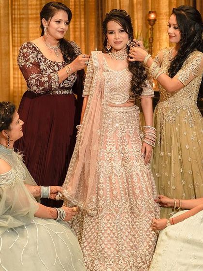 A heartwarming behind-the-scenes moment as the bridesmaids help the bride with her final touches before her engagement ceremony.