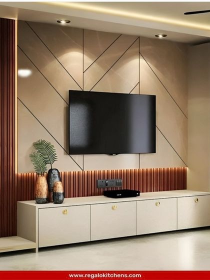 This entertainment wall features a unique geometric pattern and a mix of wood and neutral tones. The integrated shelving and cabinets offer plenty of storage.