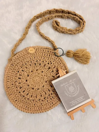 This simple and stylish round boho sling bag is one of my favorite designs. It's crocheted with sturdy yarn and features a minimalist design with a wooden button closure and a tassel for a bit of fun.