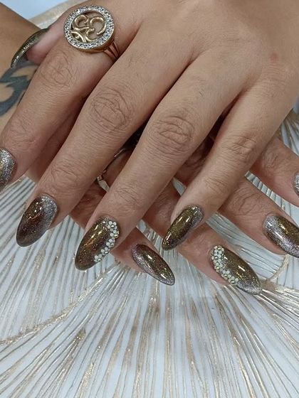 Another angle of these gorgeous cat-eye nails with rhinestone details, showing how they catch the light. Ideal for any party or special event.