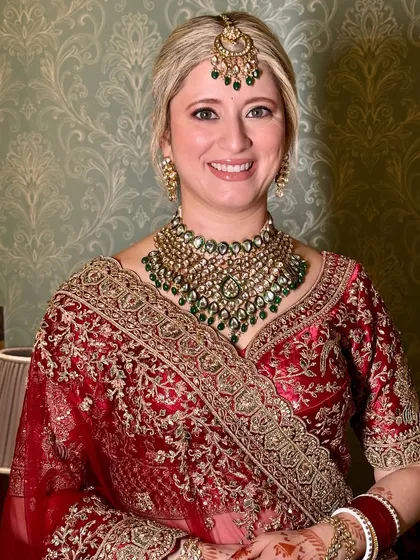 A full portrait of Vanessa looking like a perfect Indian bride. The makeup is subtle and enhances her features without being overpowering.