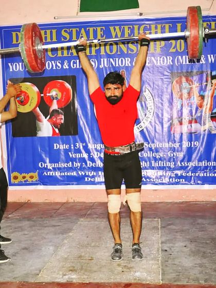 This image captures the peak of the jerk, where strength, stability, and balance come together. This moment is the culmination of a powerful drive from the legs and a solid lockout overhead.