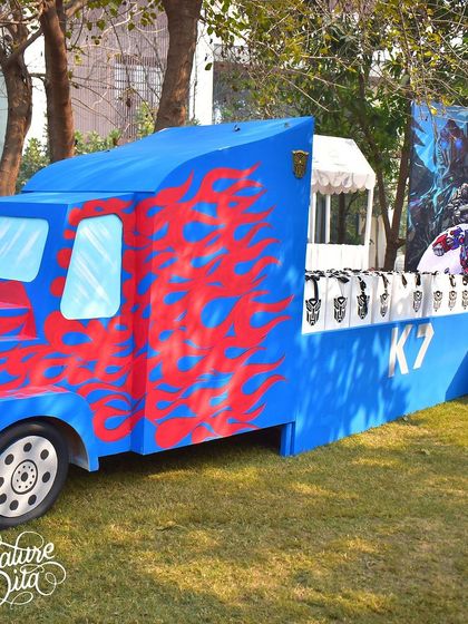 This Optimus Prime-themed truck served as a creative station for party favours. It's a functional piece of decor that perfectly matches the Transformers universe while serving a practical purpose.