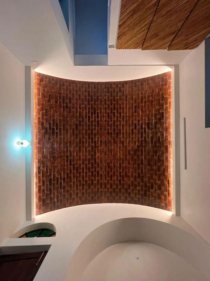 A segmental brick vault ceiling with integrated cove lighting. This technique allows us to create a wide, arched ceiling that adds volume and character to a room, while the lighting highlights the beautiful texture of the bricks.