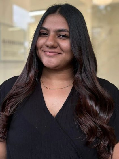 A portrait of the client, her smile as bright as her fresh hair color.