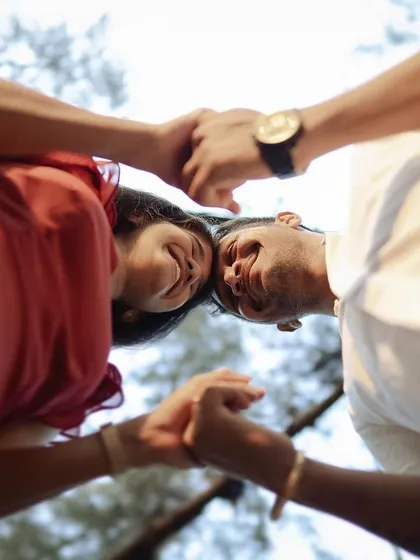 A creative, low-angle shot looking up at a couple. This unique perspective is playful and intimate, adding variety to a photo collection.