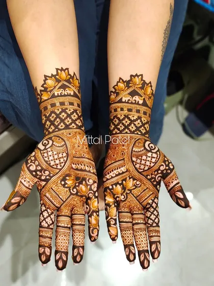 This full-hand design combines classic Indian motifs like elephants and lotuses with geometric patterns. The result is a rich and textured look that extends up the arm.