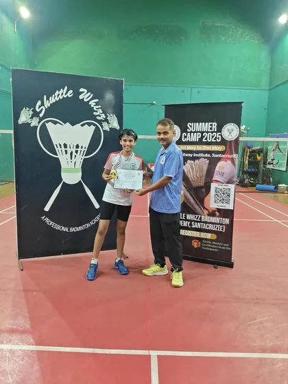 A junior player's happy moment after being awarded for her performance in the camp. Our goal is to make learning badminton a fun and rewarding experience.
