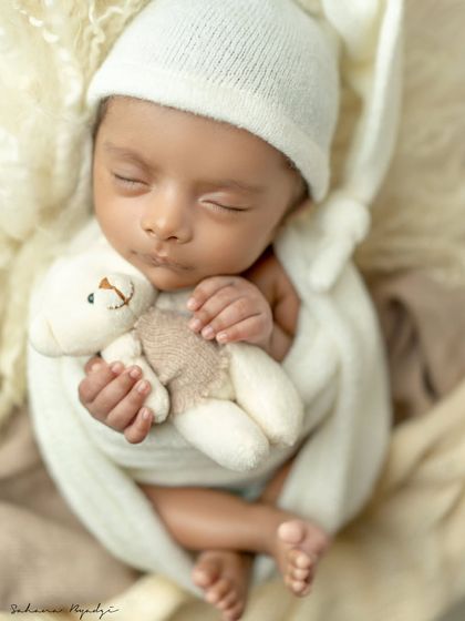 So cozy and content. This newborn is snuggled up with a teddy bear, showing the comfort and warmth I prioritize in every session.