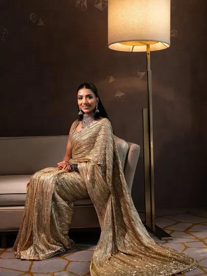 A posed, editorial-style shot. The sleek hair and soft glam makeup create a look of pure sophistication.