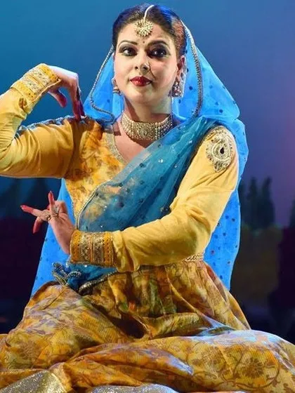 A seated pose from a Kathak performance by Mrs. Vidha Lal, highlighting the elegance and control required in this dance form.