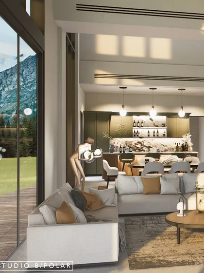 The open-plan living area flows into a bar and kitchen space, making it perfect for entertaining. The design ensures that even from the back of the room, the connection to the outdoors is never lost.