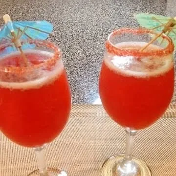 Our Strawberry Passion mocktail is a party favorite. Served in a wine glass with a spiced rim and a fun umbrella, it's a drink that looks as good as it tastes.