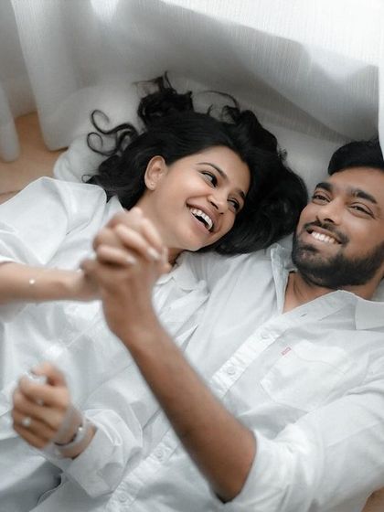 A quiet, candid moment shared between a couple during their indoor pre-wedding session. The focus here is on their natural interaction and the comfortable silence they share.