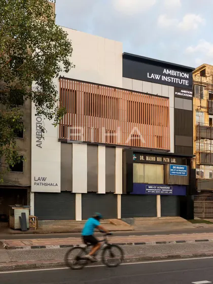 This view captures the Ambition Law Institute within its bustling urban environment. The renovated facade makes a bold statement, leaving a lasting impression that reflects the institution's professional ideology.