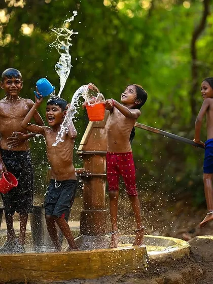 The pure energy of a village summer, frozen in time. This shot from my "Childhood Summers" series captures the simple, uninhibited happiness of kids playing near a handpump in rural Maharashtra.