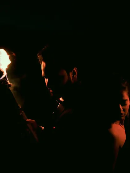 A dark and artistic portrait using the flame of a torch for dramatic lighting. This creative shot is for couples who want something edgy and different from typical pre-wedding photos.
