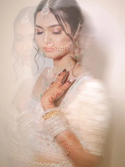 An artistic bridal portrait using a slow shutter speed to create a motion blur effect. It gives the image a dreamy, ghost-like quality.