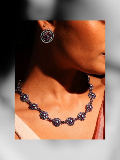 A model wearing the Amethyst and Turquoise necklace and earrings, demonstrating how the set brings a calm yet colorful statement to any look.