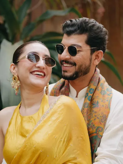 The laughter and love that fills a Haldi ceremony. This candid shot of the couple sharing a joyful moment in their coordinated yellow outfits shows the fun and relaxed side of wedding celebrations that we love to document.