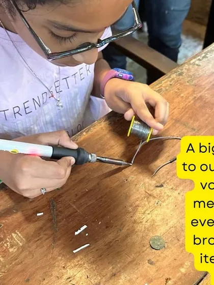 A young participant learns the essential skill of soldering. Under close supervision from our mentors, kids gain hands on experience with tools that are fundamental to electronics repair, opening up a new world of making and fixing.