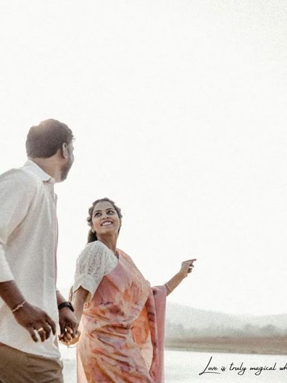 A candid walking shot by the lake, filled with smiles and natural interaction, capturing a perfect "in-between" moment.