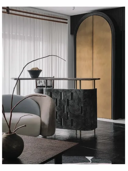 The informal bar in the 'Aria' living room is a centerpiece, carved from dark stone with intricate cutouts. It overlooks the main seating area, making it a crucial and sculptural element for socializing and entertaining.