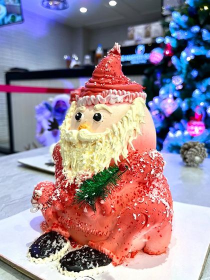 Another look at our jolly Santa Claus cake, ready to be the star of your Christmas feast. The details in his buttercream beard and hat make him almost too cute to eat.