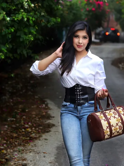 This is my take on elevating a classic. A simple white shirt and blue jeans are transformed into a high-fashion statement with the addition of a structured corset belt, proving you don't need a new wardrobe, just new ideas.
