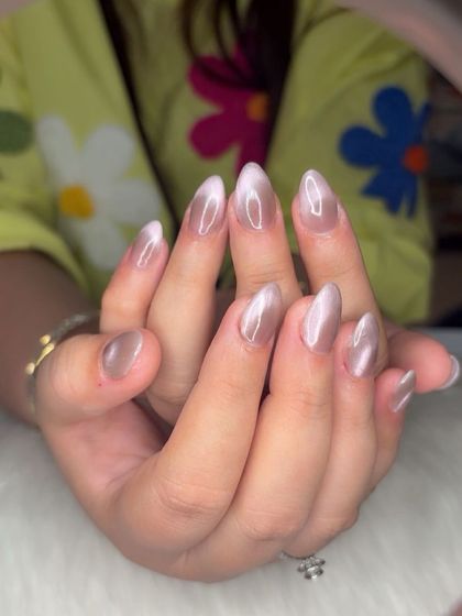 A beautiful brown cat eye effect on medium-length almond nails.