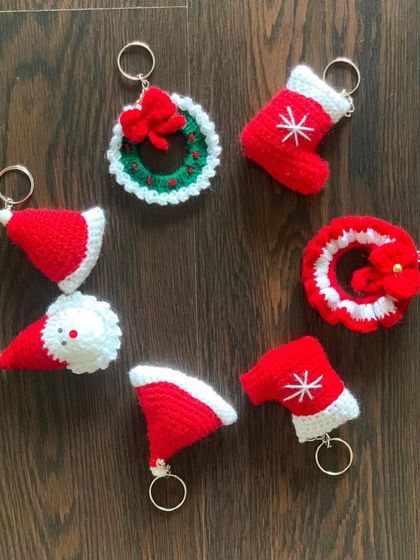 A variety of my Christmas keychains, including Santa hats, stockings, and wreaths. They are an adorable addition to any holiday gift.