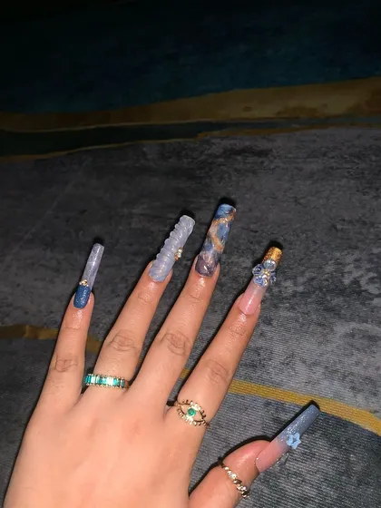 This shot showcases the length and unique shapes of the custom nail extensions.
