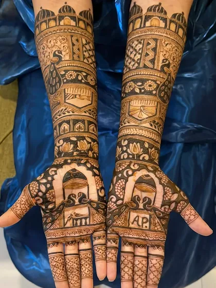 A beautiful bridal design featuring peacocks, palace architecture, and the couple's initials 'A' and 'P'. The symmetry and detail are flawless.