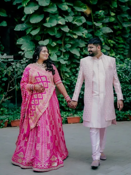 The newly engaged couple walks hand in hand, sharing a look of love and excitement for their future together.