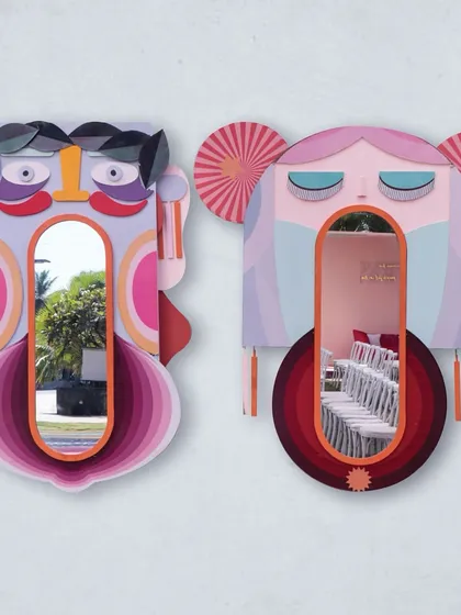 Whimsical and interactive mirrors shaped like abstract faces, allowing guests to become part of the art at the carnival.