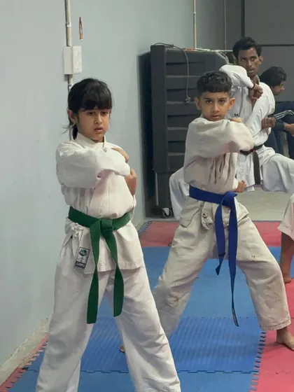 Young students demonstrating their Kata form during a belt grading exam. Focus and precision are taught from the very beginning.