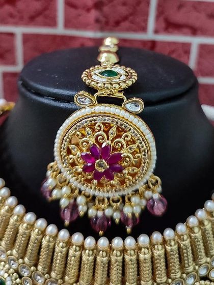 The maang tikka from this set, with a beautiful floral design in the center.