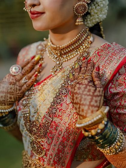 My beautiful client-turned-family, Chethana, looks timeless in this white and pink Kanchipuram saree. I designed a heavily handcrafted bridal blouse with intricate zardozi work to complement the saree's elegance for her special day.