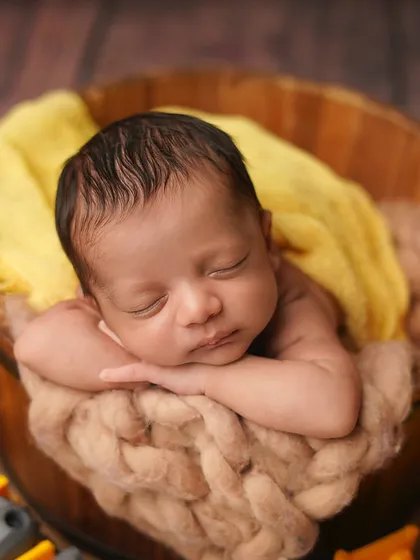 A close-up of the tiny builder, sleeping soundly after a hard day's work. His peaceful expression is a sweet contrast to the busy theme.
