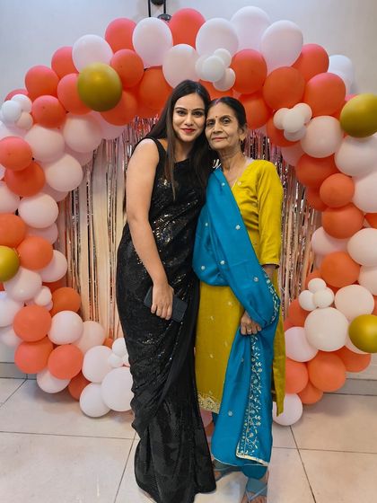 Another shot of our client with her mother, both looking elegant at a party. The black sequin saree is a versatile and glamorous choice.