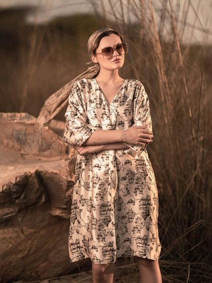 This pose, with arms crossed, gives the dress a more structured look while the flowing headscarf adds a touch of movement. It demonstrates how I direct models to present garments in varied ways.