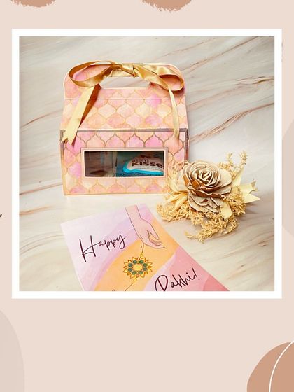 A simple and elegant Rakhi favor in a patterned carrier box, perfect for gifting chocolates or small tokens of appreciation.