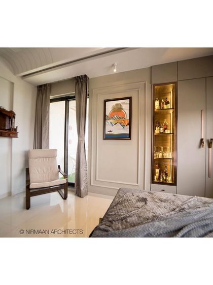 This parent's bedroom includes a small wooden mandir and a comfortable rocking chair. We design spaces that cater to the specific needs and routines of every family member.