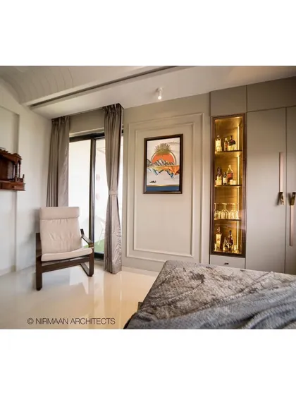 This parent's bedroom includes a small wooden mandir and a comfortable rocking chair. We design spaces that cater to the specific needs and routines of every family member.