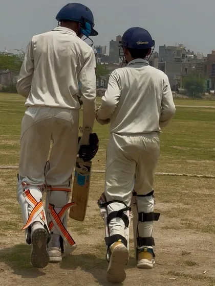Two batsmen walking off together, a picture of partnership and teamwork.